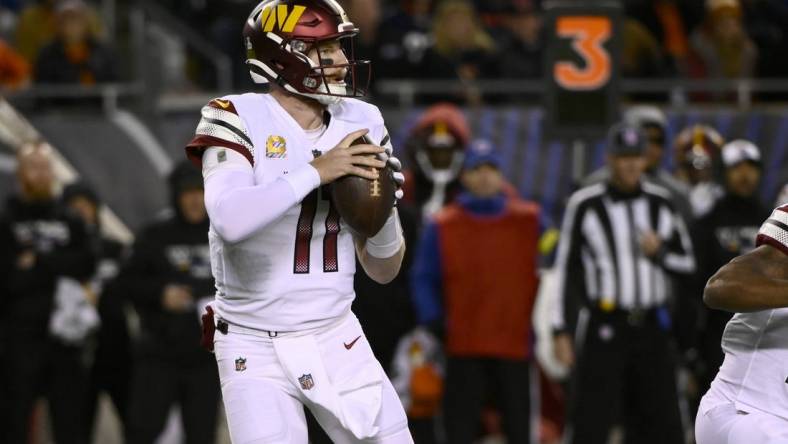 Oct 13, 2022; Chicago, Illinois, USA; Washington Commanders quarterback Carson Wentz (11) looks to pass against the Chicago Bears during the first half at Soldier Field. Mandatory Credit: Matt Marton-USA TODAY Sports