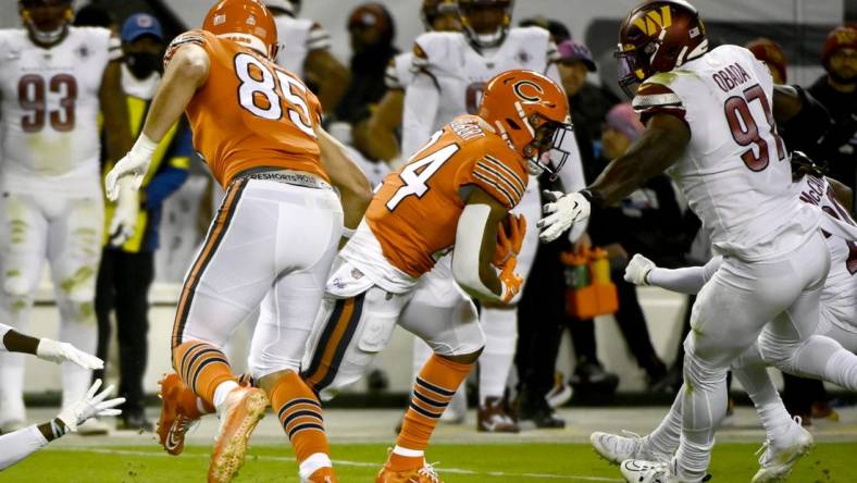 Oct 13, 2022; Chicago, Illinois, USA; Chicago Bears running back Khalil Herbert (24) runs past Washington Commanders defensive end Efe Obada (97) during the first half at Soldier Field. Mandatory Credit: Matt Marton-USA TODAY Sports