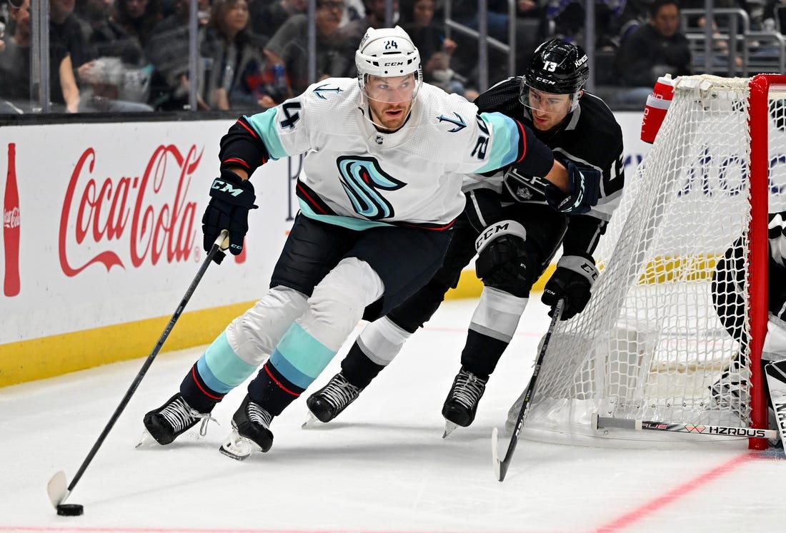 Oct 13, 2022; Los Angeles, California, USA; Seattle Kraken defenseman Jamie Oleksiak (24) and Los Angeles Kings center Gabriel Vilardi (13) battle for the puck in the third period at Crypto.com Arena. Mandatory Credit: Jayne Kamin-Oncea-USA TODAY Sports