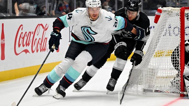 Oct 13, 2022; Los Angeles, California, USA; Seattle Kraken defenseman Jamie Oleksiak (24) and Los Angeles Kings center Gabriel Vilardi (13) battle for the puck in the third period at Crypto.com Arena. Mandatory Credit: Jayne Kamin-Oncea-USA TODAY Sports