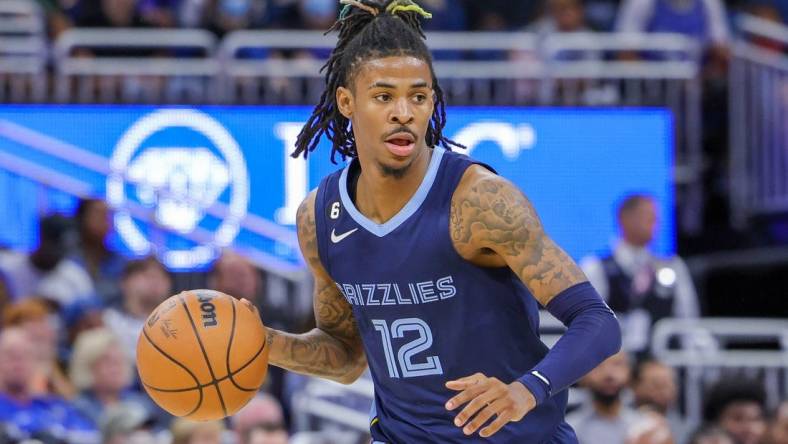 Oct 11, 2022; Orlando, Florida, USA; Memphis Grizzlies guard Ja Morant (12) brings the ball up court during the second half against the Memphis Grizzlies at Amway Center. Mandatory Credit: Mike Watters-USA TODAY Sports