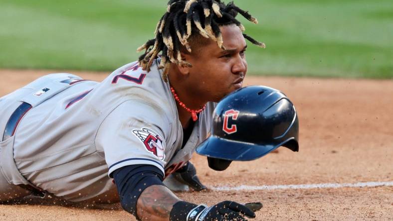 Oct 14, 2022; Bronx, New York, USA; Cleveland Guardians third baseman Jose Ramirez (11) reacts after he loses his helmet sliding safely into third base after advancing following a throwing error committed by New York Yankees third baseman Josh Donaldson (not pictured) during the tenth inning in game two of the ALDS for the 2022 MLB Playoffs at Yankee Stadium. Mandatory Credit: Vincent Carchietta-USA TODAY Sports