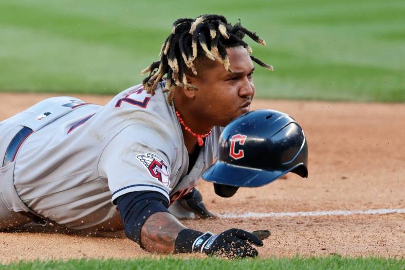 Oct 14, 2022; Bronx, New York, USA; Cleveland Guardians third baseman Jose Ramirez (11) reacts after he loses his helmet sliding safely into third base after advancing following a throwing error committed by New York Yankees third baseman Josh Donaldson (not pictured) during the tenth inning in game two of the ALDS for the 2022 MLB Playoffs at Yankee Stadium. Mandatory Credit: Vincent Carchietta-USA TODAY Sports