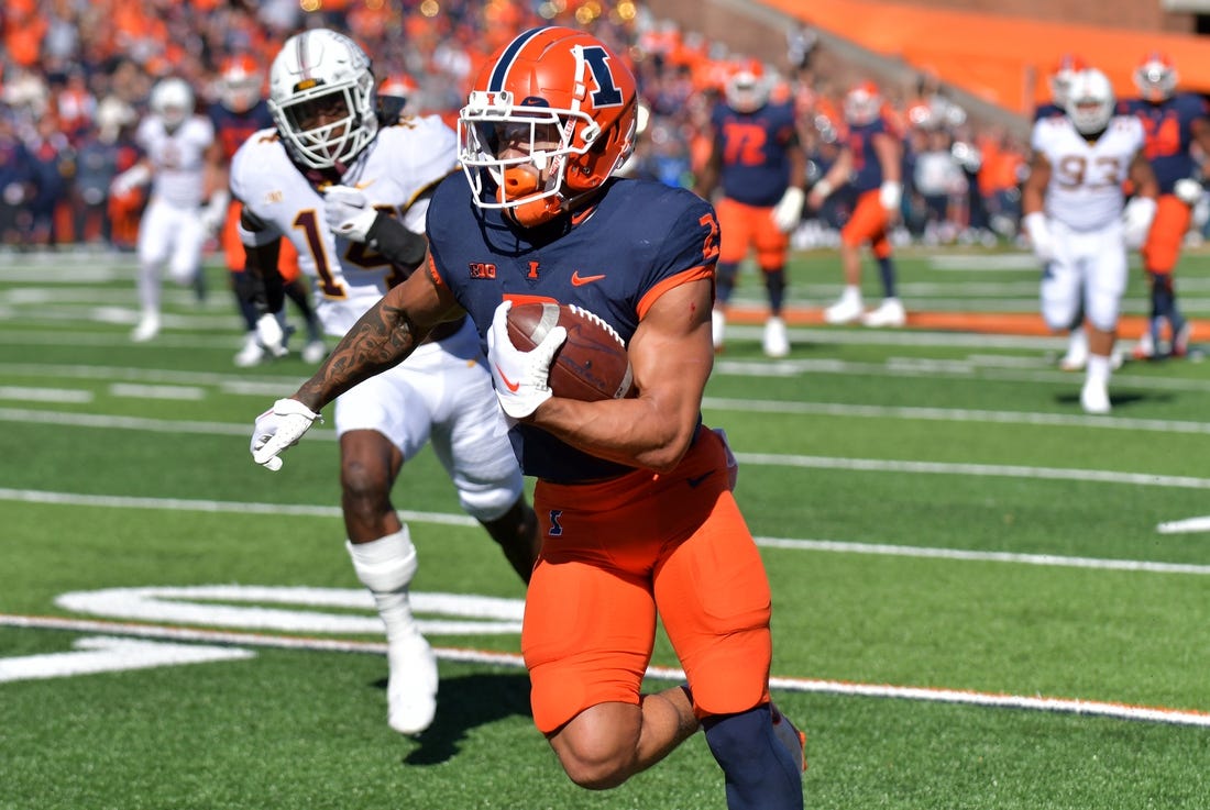 Oct 15, 2022; Champaign, Illinois, USA;  Illinois Fighting Illini running back Chase Brown (2) scores a touchdown during the first half against the Minnesota Golden Gophers at Memorial Stadium. Mandatory Credit: Ron Johnson-USA TODAY Sports