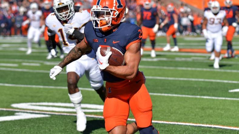 Oct 15, 2022; Champaign, Illinois, USA;  Illinois Fighting Illini running back Chase Brown (2) scores a touchdown during the first half against the Minnesota Golden Gophers at Memorial Stadium. Mandatory Credit: Ron Johnson-USA TODAY Sports