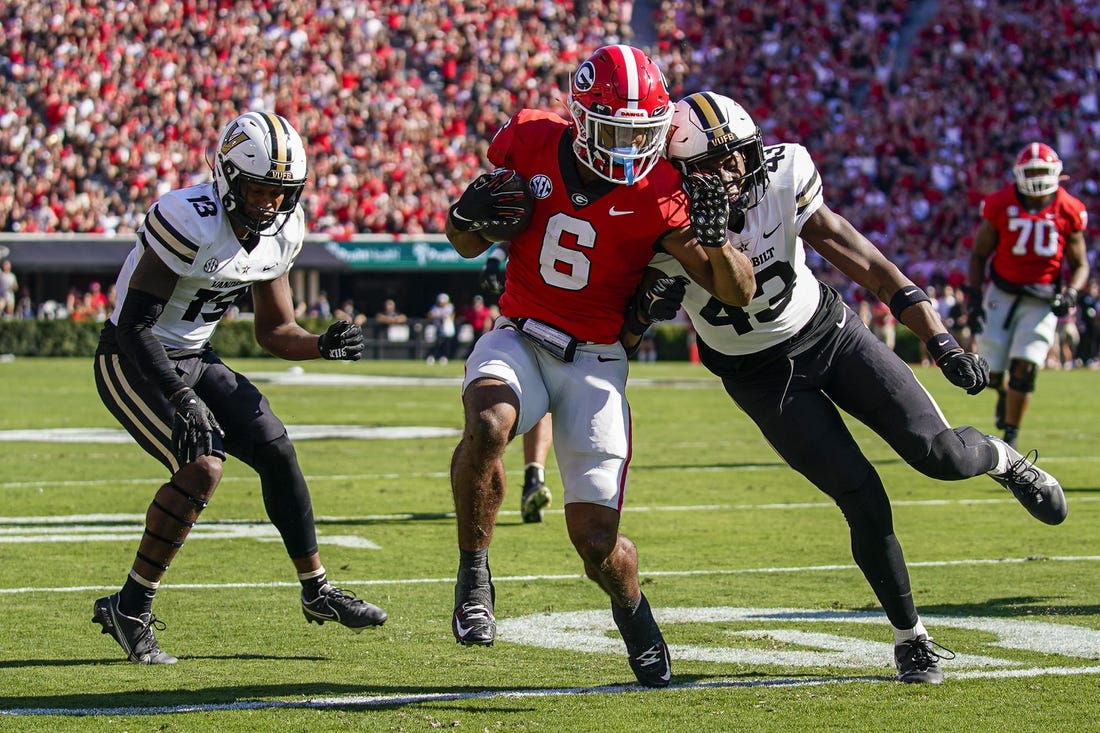 Oct 15, 2022; Athens, Georgia, USA; Georgia Bulldogs running back Kenny McIntosh (6) scores a touchdown past Vanderbilt Commodores linebacker De'Rickey Wright (43) after catching a pass during the first quarter at Sanford Stadium. Mandatory Credit: Dale Zanine-USA TODAY Sports