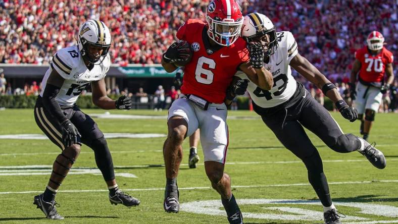 Oct 15, 2022; Athens, Georgia, USA; Georgia Bulldogs running back Kenny McIntosh (6) scores a touchdown past Vanderbilt Commodores linebacker De'Rickey Wright (43) after catching a pass during the first quarter at Sanford Stadium. Mandatory Credit: Dale Zanine-USA TODAY Sports