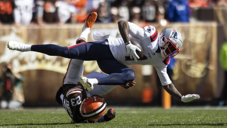 Oct 16, 2022; Cleveland, Ohio, USA; New England Patriots wide receiver DeVante Parker (1) falls over Cleveland Browns cornerback Martin Emerson Jr. (23) during the first quarter at FirstEnergy Stadium. Mandatory Credit: Scott Galvin-USA TODAY Sports