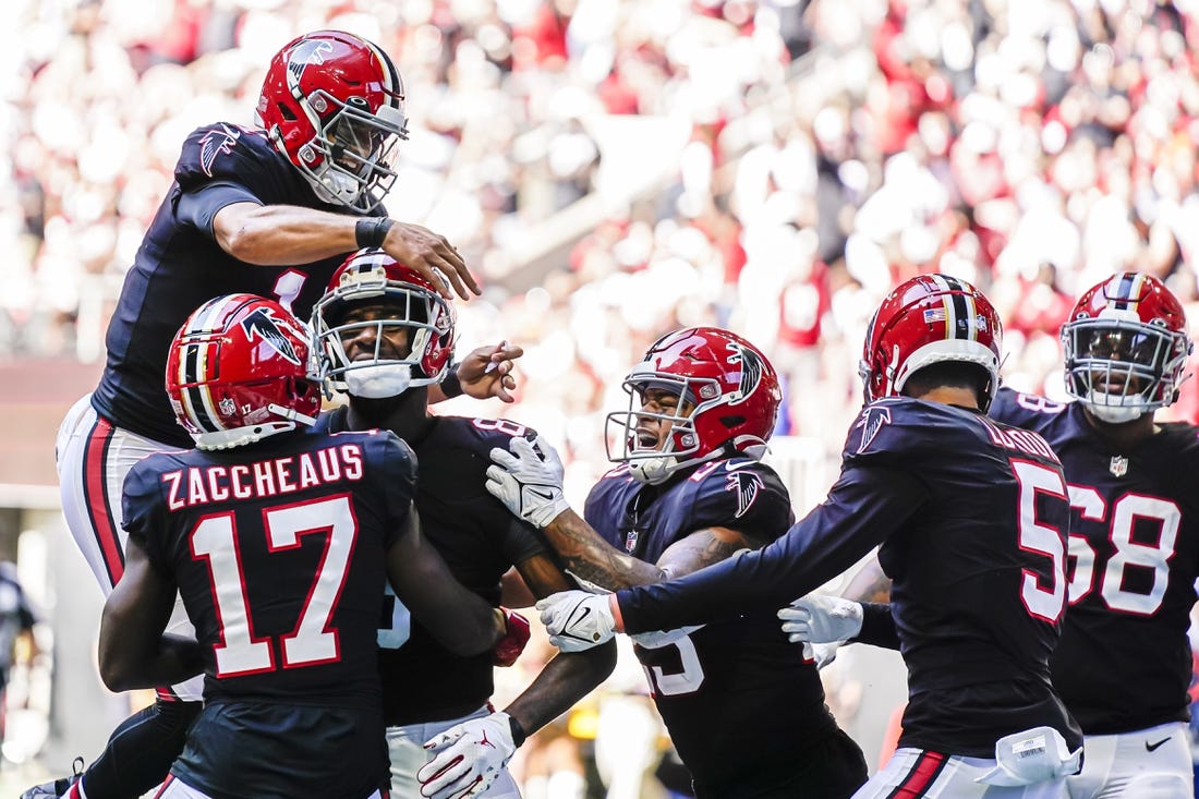 Oct 16, 2022; Atlanta, Georgia, USA; Atlanta Falcons players including quarterback Marcus Mariota (1) react with tight end Kyle Pitts (8) after his touchdown catch against the San Francisco 49ers during the second half at Mercedes-Benz Stadium. Mandatory Credit: Dale Zanine-USA TODAY Sports