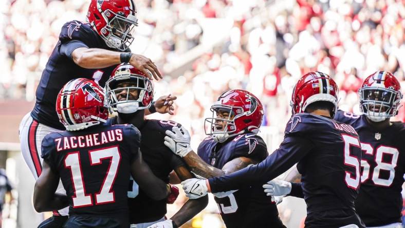 Oct 16, 2022; Atlanta, Georgia, USA; Atlanta Falcons players including quarterback Marcus Mariota (1) react with tight end Kyle Pitts (8) after his touchdown catch against the San Francisco 49ers during the second half at Mercedes-Benz Stadium. Mandatory Credit: Dale Zanine-USA TODAY Sports