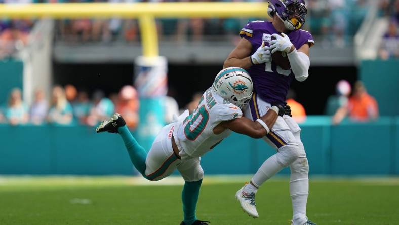 Miami Dolphins cornerback Nik Needham (40) makes a tackle on Minnesota Vikings wide receiver Adam Thielen (19) during the first half of an NFL game. Needham left the game after the play with a leg injury. Hard Rock Stadium, Miami Gardens, Oct. 16, 2022.

Vikings V Dolphins 26