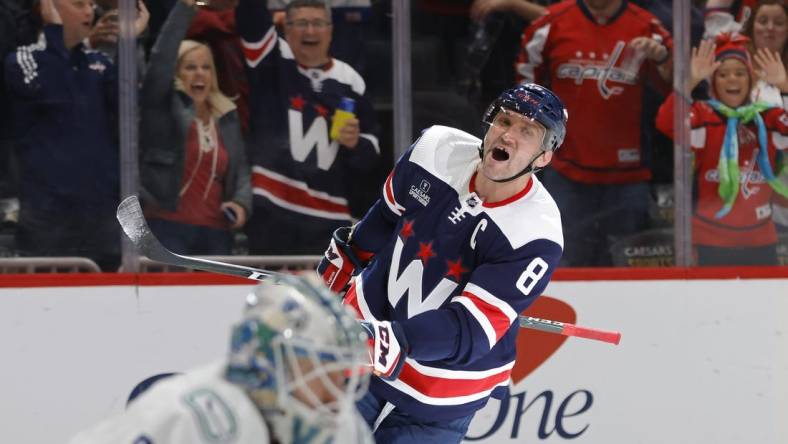 Oct 17, 2022; Washington, District of Columbia, USA; Washington Capitals left wing Alex Ovechkin (8) celebrates after scoring a goal on Vancouver Canucks goaltender Thatcher Demko (35) in the third period at Capital One Arena. Mandatory Credit: Geoff Burke-USA TODAY Sports