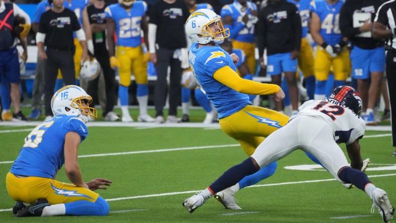 Oct 17, 2022; Inglewood, California, USA; Los Angeles Chargers place kicker Dustin Hopkins (6) kicks a 39-yard fielg goal out of the hold of punter JK Scott (16) in overtime against the Denver Broncos at SoFi Stadium. Mandatory Credit: Kirby Lee-USA TODAY Sports