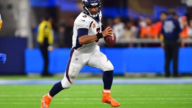 Oct 17, 2022; Inglewood, California, USA; Denver Broncos quarterback Russell Wilson (3) runs the ball against the Los Angeles Chargers during the second half at SoFi Stadium. Mandatory Credit: Gary A. Vasquez-USA TODAY Sports