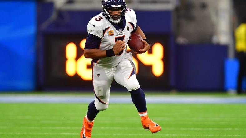 Oct 17, 2022; Inglewood, California, USA; Denver Broncos quarterback Russell Wilson (3) runs the ball against the Los Angeles Chargers during the second half at SoFi Stadium. Mandatory Credit: Gary A. Vasquez-USA TODAY Sports