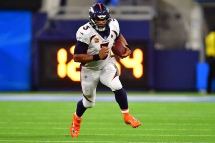 Oct 17, 2022; Inglewood, California, USA; Denver Broncos quarterback Russell Wilson (3) runs the ball against the Los Angeles Chargers during the second half at SoFi Stadium. Mandatory Credit: Gary A. Vasquez-USA TODAY Sports