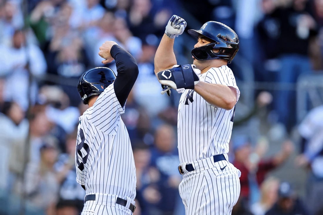 Oct 18, 2022; Bronx, New York, USA; New York Yankees first baseman Anthony Rizzo (48) congratulates designated hitter Giancarlo Stanton (right) after he hit a three-run home run against the Cleveland Guardians during the first inning in game five of the ALDS for the 2022 MLB Playoffs at Yankee Stadium. Mandatory Credit: Brad Penner-USA TODAY Sports