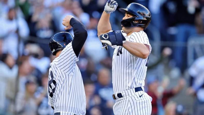 Oct 18, 2022; Bronx, New York, USA; New York Yankees first baseman Anthony Rizzo (48) congratulates designated hitter Giancarlo Stanton (right) after he hit a three-run home run against the Cleveland Guardians during the first inning in game five of the ALDS for the 2022 MLB Playoffs at Yankee Stadium. Mandatory Credit: Brad Penner-USA TODAY Sports