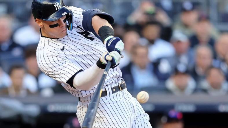 Oct 18, 2022; Bronx, New York, USA; New York Yankees right fielder Aaron Judge (99) hits a home run against the Cleveland Guardians during the second inning in game five of the ALDS for the 2022 MLB Playoffs at Yankee Stadium. Mandatory Credit: Brad Penner-USA TODAY Sports