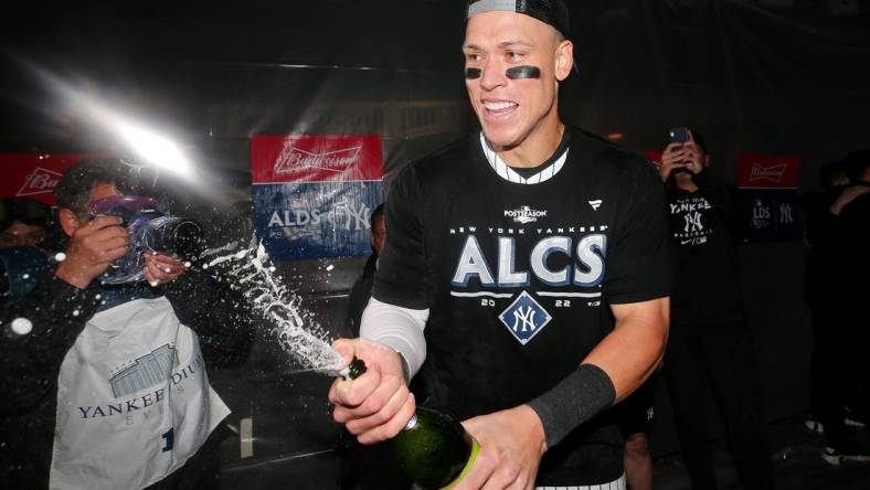 Oct 18, 2022; Bronx, New York, USA; New York Yankees right fielder Aaron Judge (99) celebrates in the clubhouse after their win against the Cleveland Guardians in game five of the ALDS for the 2022 MLB Playoffs at Yankee Stadium. Mandatory Credit: Brad Penner-USA TODAY Sports