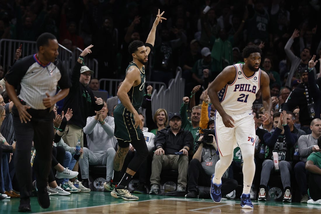 Oct 18, 2022; Boston, Massachusetts, USA; Boston Celtics forward Jayson Tatum (0) signals after making a three point basket over Philadelphia 76ers center Joel Embiid (21) during the first quarter at TD Garden. Mandatory Credit: Winslow Townson-USA TODAY Sports