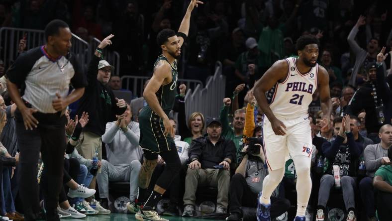 Oct 18, 2022; Boston, Massachusetts, USA; Boston Celtics forward Jayson Tatum (0) signals after making a three point basket over Philadelphia 76ers center Joel Embiid (21) during the first quarter at TD Garden. Mandatory Credit: Winslow Townson-USA TODAY Sports