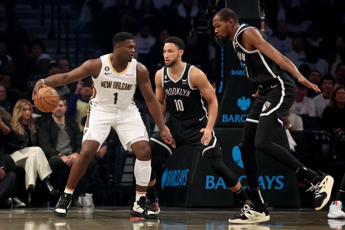 Oct 19, 2022; Brooklyn, New York, USA; New Orleans Pelicans forward Zion Williamson (1) controls the ball against Brooklyn Nets guard Ben Simmons (10) and forward Kevin Durant (7) during the first quarter at Barclays Center. Mandatory Credit: Brad Penner-USA TODAY Sports