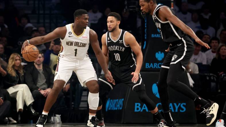 Oct 19, 2022; Brooklyn, New York, USA; New Orleans Pelicans forward Zion Williamson (1) controls the ball against Brooklyn Nets guard Ben Simmons (10) and forward Kevin Durant (7) during the first quarter at Barclays Center. Mandatory Credit: Brad Penner-USA TODAY Sports