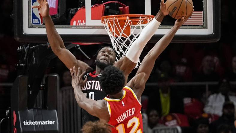 Oct 19, 2022; Atlanta, Georgia, USA; Houston Rockets forward Bruno Fernando (20) blocks a shot by Atlanta Hawks forward De'Andre Hunter (12) during the first quarter at State Farm Arena. Mandatory Credit: Dale Zanine-USA TODAY Sports