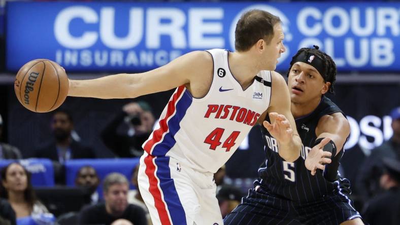 Oct 19, 2022; Detroit, Michigan, USA;  Detroit Pistons forward Bojan Bogdanovic (44) is defended by Orlando Magic forward Paolo Banchero (5) in the first half at Little Caesars Arena. Mandatory Credit: Rick Osentoski-USA TODAY Sports