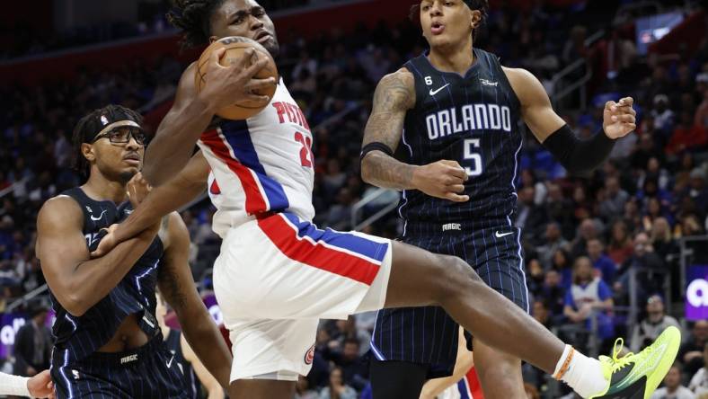 Oct 19, 2022; Detroit, Michigan, USA;  Detroit Pistons center Isaiah Stewart (28) grabs the rebound over center Wendell Carter Jr. (34) and Orlando Magic forward Paolo Banchero (5) in the first half at Little Caesars Arena. Mandatory Credit: Rick Osentoski-USA TODAY Sports