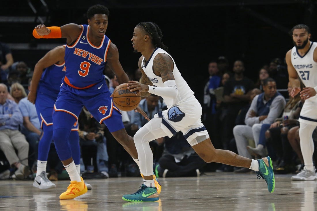 Oct 19, 2022; Memphis, Tennessee, USA; Memphis Grizzlies guard Ja Morant (12) dribbles as New York Knicks guard RJ Barrett (9) defends during the first half at FedExForum. Mandatory Credit: Petre Thomas-USA TODAY Sports