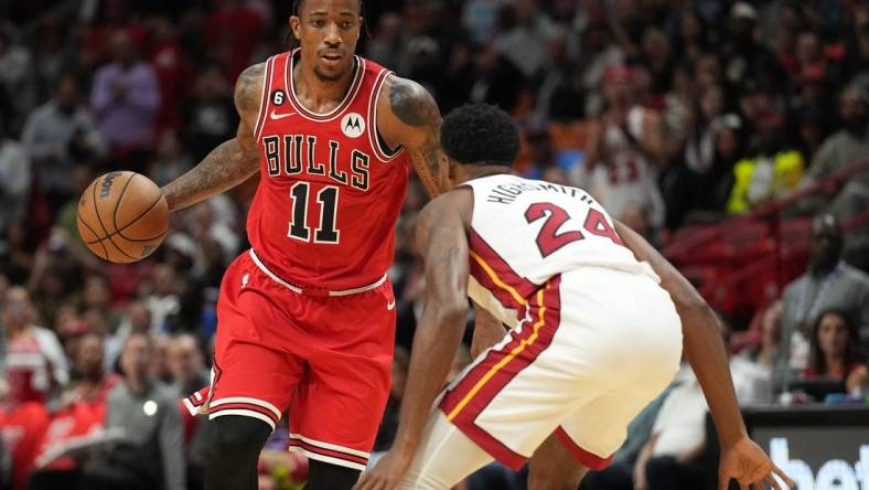 Oct 19, 2022; Miami, Florida, USA; Chicago Bulls forward DeMar DeRozan (11) brings the ball up the court as Miami Heat forward Haywood Highsmith (24) defends in the first half at FTX Arena. Mandatory Credit: Jim Rassol-USA TODAY Sports