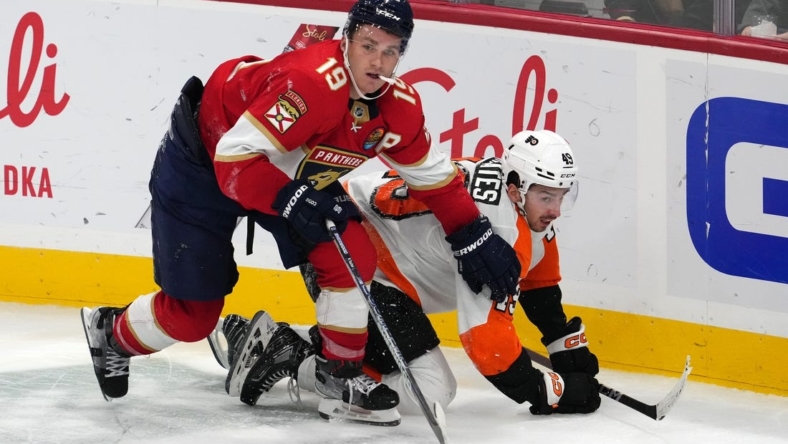 Oct 19, 2022; Sunrise, Florida, USA; Florida Panthers left wing Matthew Tkachuk (19) checks Philadelphia Flyers left wing Noah Cates (49) to the ice during the third period at FLA Live Arena. Mandatory Credit: Jasen Vinlove-USA TODAY Sports