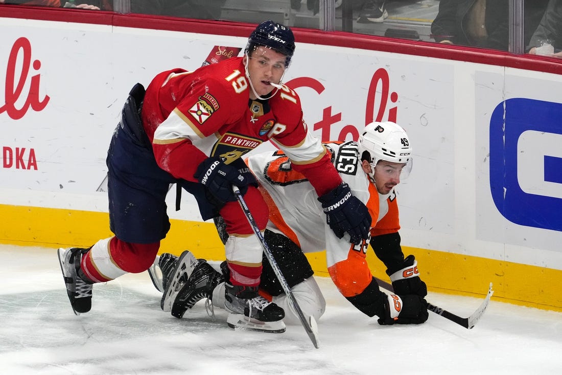 Oct 19, 2022; Sunrise, Florida, USA; Florida Panthers left wing Matthew Tkachuk (19) checks Philadelphia Flyers left wing Noah Cates (49) to the ice during the third period at FLA Live Arena. Mandatory Credit: Jasen Vinlove-USA TODAY Sports