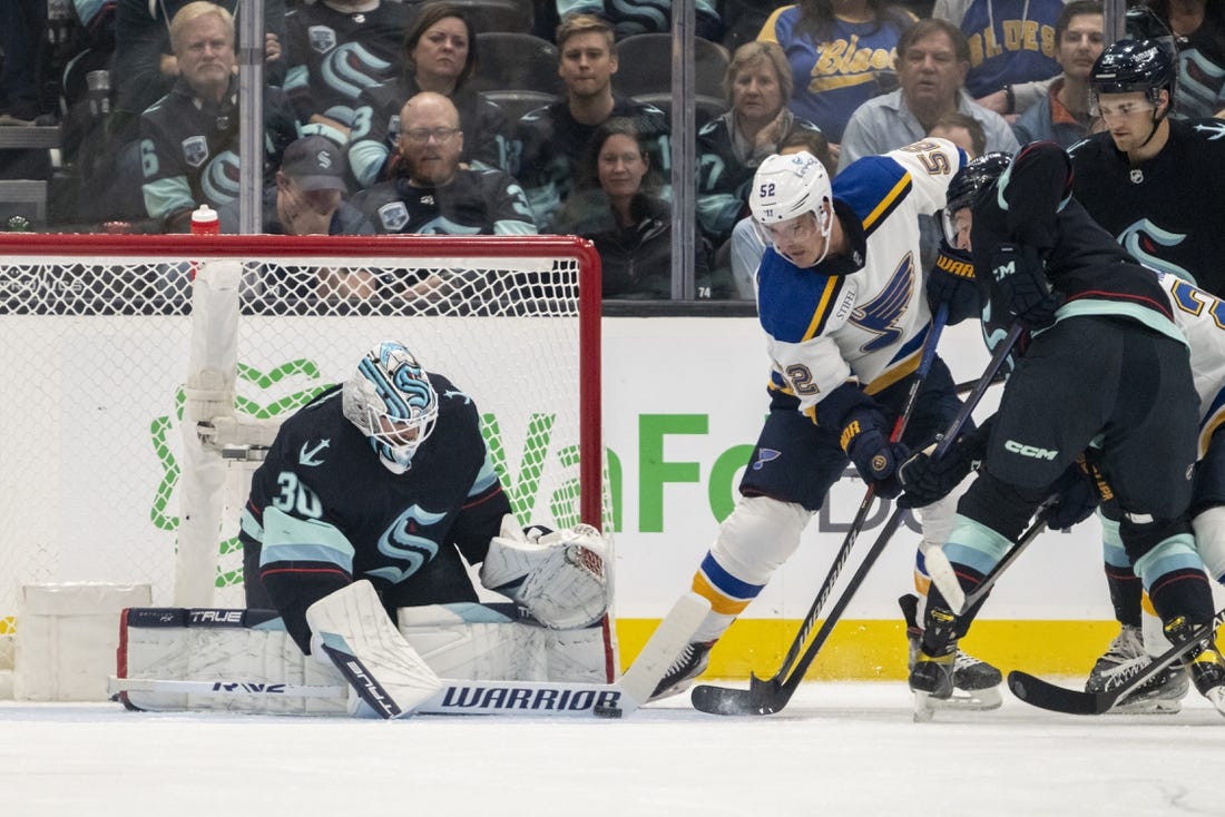 Oct 19, 2022; Seattle, Washington, USA; Seattle Kraken goalkeeper Martin Jones (30) stops a shot by St. Louis Blues forward Noel Acciari (52) during the first period at Climate Pledge Arena. Mandatory Credit: Stephen Brashear-USA TODAY Sports