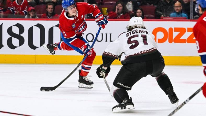 Oct 20, 2022; Montreal, Quebec, CAN; Montreal Canadiens right wing Brendan Gallagher (11) shoots the puck while Arizona Coyotes defenseman Troy Stecher (51) defends during the first period at Bell Centre. Mandatory Credit: David Kirouac-USA TODAY Sports