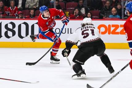 Oct 20, 2022; Montreal, Quebec, CAN; Montreal Canadiens right wing Brendan Gallagher (11) shoots the puck while Arizona Coyotes defenseman Troy Stecher (51) defends during the first period at Bell Centre. Mandatory Credit: David Kirouac-USA TODAY Sports