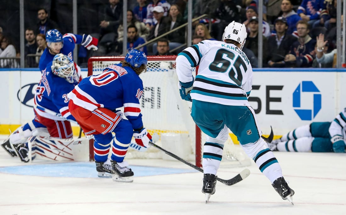 Oct 20, 2022; New York, New York, USA; San Jose Sharks defenseman Erik Karlsson (65) scores the game-winning goal in overtime against the New York Rangers at Madison Square Garden. Mandatory Credit: Danny Wild-USA TODAY Sports