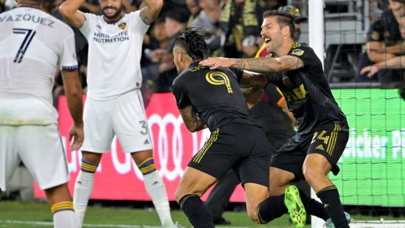 Oct 20, 2022; Los Angeles, California, US; Los Angeles FC midfielder Ryan Hollingshead (24) celebrates with forward Cristian Arango (9) after a goal during the second half of the MLS Cup Playoff semifinal against the Los Angeles Galaxy at Banc Of California Stadium. Mandatory Credit: Jayne Kamin-Oncea-USA TODAY Sports