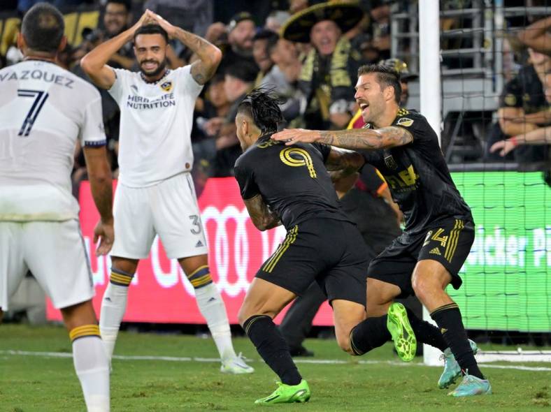 Oct 20, 2022; Los Angeles, California, US; Los Angeles FC midfielder Ryan Hollingshead (24) celebrates with forward Cristian Arango (9) after a goal during the second half of the MLS Cup Playoff semifinal against the Los Angeles Galaxy at Banc Of California Stadium. Mandatory Credit: Jayne Kamin-Oncea-USA TODAY Sports