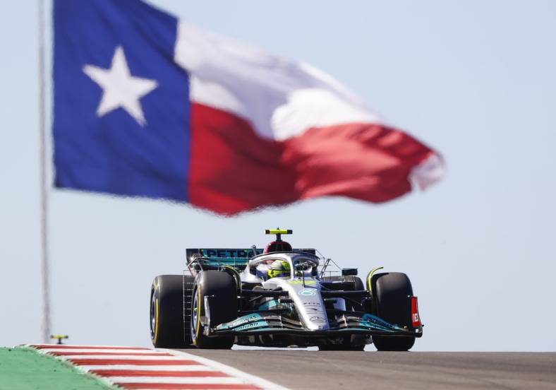 Oct 21, 2022; Austin, Texas, USA;  Mercedes-AMG Petronas driver Lewis Hamilton (44) passes the Texas flag during practice for the U.S. Grand Prix at Circuit of the Americas. Mandatory Credit: Erich Schlegel-USA TODAY Sports