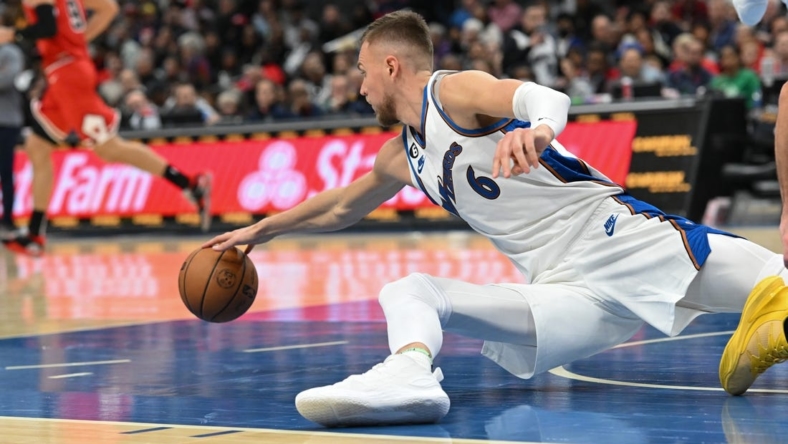Oct 21, 2022; Washington, District of Columbia, USA;  Washington Wizards center Kristaps Porzingis (6) dives for a loose ball during the second half against the Chicago Bulls  at Capital One Arena. Mandatory Credit: Tommy Gilligan-USA TODAY Sports