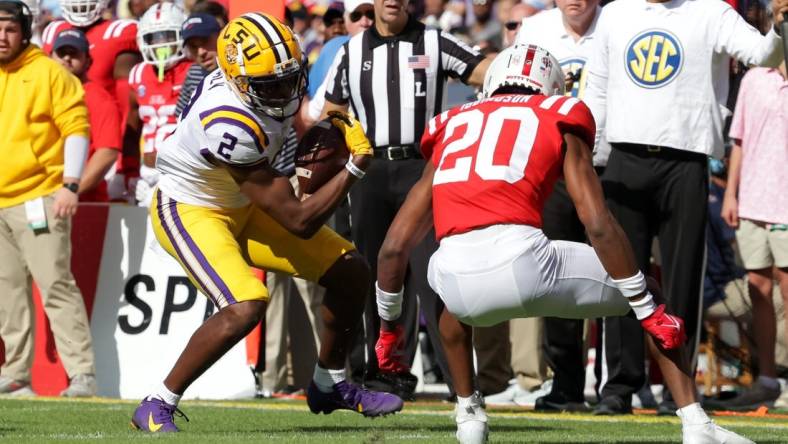 Oct 22, 2022; Baton Rouge, Louisiana, USA;  LSU Tigers wide receiver Kyren Lacy (2) is tackled by Mississippi Rebels cornerback Davison Igbinosun (20) during the first half at Tiger Stadium. Mandatory Credit: Stephen Lew-USA TODAY Sports