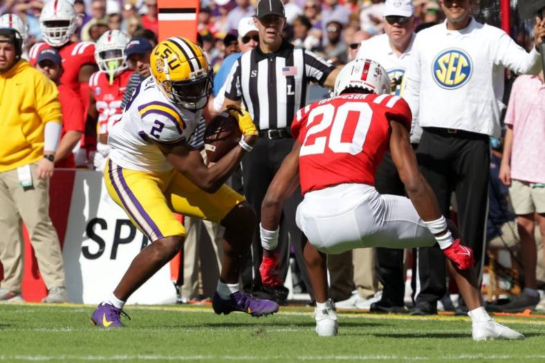 Oct 22, 2022; Baton Rouge, Louisiana, USA;  LSU Tigers wide receiver Kyren Lacy (2) is tackled by Mississippi Rebels cornerback Davison Igbinosun (20) during the first half at Tiger Stadium. Mandatory Credit: Stephen Lew-USA TODAY Sports