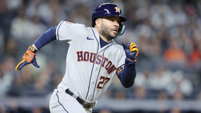 Oct 22, 2022; Bronx, New York, USA; Houston Astros second baseman Jose Altuve (27) hits a double in the fifth inn against the New York Yankees during game three of the ALCS for the 2022 MLB Playoffs at Yankee Stadium. Mandatory Credit: Brad Penner-USA TODAY Sports