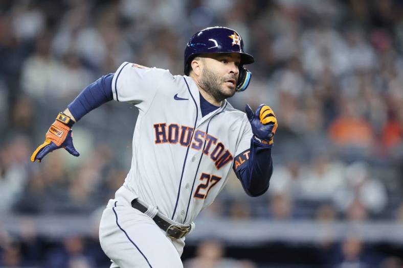 Oct 22, 2022; Bronx, New York, USA; Houston Astros second baseman Jose Altuve (27) hits a double in the fifth inn against the New York Yankees during game three of the ALCS for the 2022 MLB Playoffs at Yankee Stadium. Mandatory Credit: Brad Penner-USA TODAY Sports