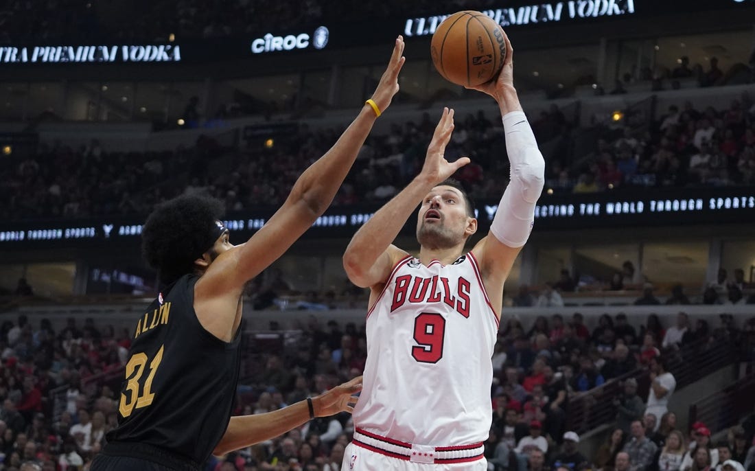 Oct 22, 2022; Chicago, Illinois, USA; Chicago Bulls center Nikola Vucevic (9) shoots Cleveland Cavaliers center Jarrett Allen (31) during the first quarter at United Center. Mandatory Credit: David Banks-USA TODAY Sports