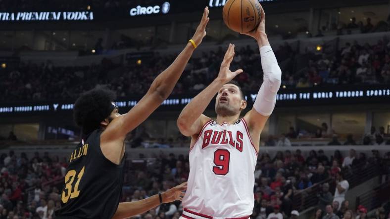 Oct 22, 2022; Chicago, Illinois, USA; Chicago Bulls center Nikola Vucevic (9) shoots Cleveland Cavaliers center Jarrett Allen (31) during the first quarter at United Center. Mandatory Credit: David Banks-USA TODAY Sports