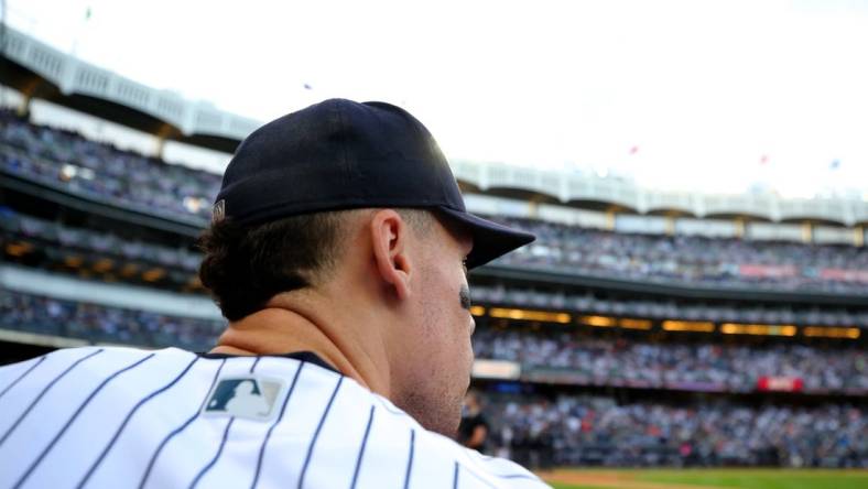 Oct 22, 2022; Bronx, New York, USA; New York Yankees right fielder Aaron Judge (99) looks out of the dugout before taking the field for the start of game three of the ALCS against the Houston Astros during the 2022 MLB Playoffs at Yankee Stadium. Mandatory Credit: Brad Penner-USA TODAY Sports